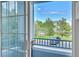 Balcony view overlooking a parking lot and common area featuring trees and well-maintained lawns at 5255 Memphis St # 317, Denver, CO 80239