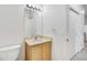 Simple bathroom featuring a vanity with a sink, a mirror, and a toilet, complemented by neutral tones at 5255 Memphis St # 317, Denver, CO 80239