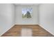 Bright bedroom with hardwood floors, a large window with green views, and ample space at 5255 Memphis St # 317, Denver, CO 80239
