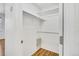 Organized closet with shelving and a wooden floor, maximizing storage space for a tidy home at 5255 Memphis St # 317, Denver, CO 80239