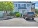 Exterior of a multi-unit residence showing parking, landscaping, and a partial view of the building at 5255 Memphis St # 317, Denver, CO 80239