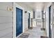 Hallway with neutral grey walls, contrasting blue doors, and views to the outside at 5255 Memphis St # 317, Denver, CO 80239