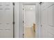 Hallway view leading to a bathroom with neutral tones and wooden accents, providing a serene transition at 5255 Memphis St # 317, Denver, CO 80239
