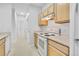 Efficient kitchen layout with modern appliances and wooden cabinets, providing a comfortable cooking environment at 5255 Memphis St # 317, Denver, CO 80239