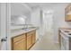 Clean kitchen featuring a double basin sink, white appliances, and wooden cabinets, maximizing functionality at 5255 Memphis St # 317, Denver, CO 80239