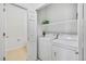 Functional laundry area with a washer, dryer, storage shelf, and a convenient closet, ensuring seamless chores at 5255 Memphis St # 317, Denver, CO 80239