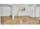 Open-concept living space with wood floors, white walls, and views of the kitchen at 5255 Memphis St # 317, Denver, CO 80239