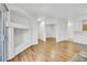 Bright living room with built-ins, light floors, and an open concept design at 5255 Memphis St # 317, Denver, CO 80239