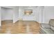 Open living room featuring light wood floors, white walls, and archways to other rooms at 5255 Memphis St # 317, Denver, CO 80239
