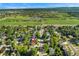 Aerial view showcasing the neighborhood and the nearby park with a pond at 5870 Quail St, Arvada, CO 80004