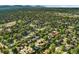 The home's location in a verdant, tree-lined neighborhood is showcased in this aerial view at 5870 Quail St, Arvada, CO 80004