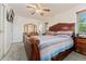 Bedroom featuring a large wooden bed frame, ceiling fan, and two windows, creating a comfortable retreat at 5870 Quail St, Arvada, CO 80004