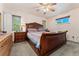 Bedroom featuring a large wooden bed frame, ceiling fan, and two windows, creating a comfortable retreat at 5870 Quail St, Arvada, CO 80004