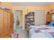 Bedroom with a built in dresser and access to the Primary bath and walk in closet at 5870 Quail St, Arvada, CO 80004