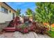 Charming outdoor deck with dining set and grill, surrounded by lush greenery and beautiful landscaping at 5870 Quail St, Arvada, CO 80004