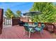 Inviting deck with outdoor dining set and grill, ideal for enjoying the outdoors and entertaining guests at 5870 Quail St, Arvada, CO 80004
