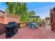 Outdoor deck with seating area and grill, perfect for summer gatherings and outdoor dining at 5870 Quail St, Arvada, CO 80004