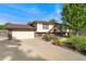 Charming home featuring an attached garage, a well-manicured front yard, and mature landscaping at 5870 Quail St, Arvada, CO 80004