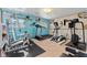 Home gym with various exercise machines and wood-paneled walls, providing a convenient workout space at 5870 Quail St, Arvada, CO 80004