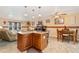 Open concept kitchen features an island with granite countertops and views into living and dining areas at 5870 Quail St, Arvada, CO 80004