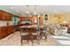 Kitchen featuring a large island with seating, wooden cabinets, and views into the adjacent living room at 5870 Quail St, Arvada, CO 80004