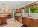 Open kitchen with tile floors, modern cabinets, and access to the dining area at 5870 Quail St, Arvada, CO 80004