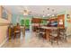 Eat in kitchen with a granite island, tile floors, and wood cabinets at 5870 Quail St, Arvada, CO 80004