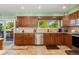 Updated kitchen with tile floors, stainless steel dishwasher, and natural light at 5870 Quail St, Arvada, CO 80004