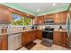 Bright kitchen featuring stainless steel appliances and a window at 5870 Quail St, Arvada, CO 80004