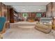 Spacious living room with wood paneled walls, tiered floor, and comfortable seating, great for entertaining at 5870 Quail St, Arvada, CO 80004