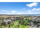 Community aerial view showcasing golf course, neighborhood, and distant mountain views at 13850 E Marina Dr # 304, Aurora, CO 80014