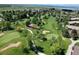 Picturesque aerial view of the golf course showcasing lush greenery, ponds, and surrounding residences at 13850 E Marina Dr # 304, Aurora, CO 80014