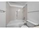 Bathroom showcasing a tiled shower/tub combo, grab bar, and a well-lit, bright interior at 13850 E Marina Dr # 304, Aurora, CO 80014
