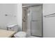 Bright bathroom featuring a shower with glass doors and convenient grab bar at 13850 E Marina Dr # 304, Aurora, CO 80014