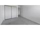 Bedroom with neutral carpet and large closet space and a glimpse of the hallway at 13850 E Marina Dr # 304, Aurora, CO 80014