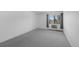 Bedroom featuring a window with blinds, neutral carpet, and baseboard heating at 13850 E Marina Dr # 304, Aurora, CO 80014
