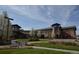 Inviting community building exterior with landscaped grounds, walkways, and seating areas at 13850 E Marina Dr # 304, Aurora, CO 80014