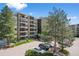 Modern condo building showcasing a manicured entrance, mature trees, and well-maintained landscaping at 13850 E Marina Dr # 304, Aurora, CO 80014