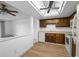 Cozy kitchen featuring wood cabinets, laminate countertops, and new flooring at 13850 E Marina Dr # 304, Aurora, CO 80014