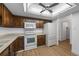 Practical kitchen features white appliances, plenty of cabinet space, and modern flooring at 13850 E Marina Dr # 304, Aurora, CO 80014