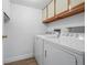 Functional laundry room with washer, dryer, and overhead cabinets for storage at 13850 E Marina Dr # 304, Aurora, CO 80014