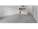 Inviting living room with neutral carpet, showcasing an open layout and a view into the adjacent kitchen at 13850 E Marina Dr # 304, Aurora, CO 80014