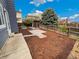 Fenced backyard featuring a patio and mulched landscaping at 8536 S Upham Way, Littleton, CO 80128