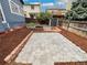 Landscaped backyard includes a fenced yard, garden beds, and a patio area, perfect for entertaining at 8536 S Upham Way, Littleton, CO 80128