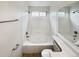 Clean bathroom with a soaking tub, tile surround, and modern fixtures at 8536 S Upham Way, Littleton, CO 80128