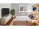 Cozy bedroom featuring a comfortable bed, dresser, and bright window at 8536 S Upham Way, Littleton, CO 80128