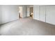 Spacious bedroom with carpet, neutral paint, closet, and access to the hallway and bathroom at 8536 S Upham Way, Littleton, CO 80128