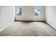 Bedroom with carpeted floor and two windows at 8536 S Upham Way, Littleton, CO 80128
