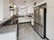Modern kitchen with stainless steel appliances, granite counters and tiled floor at 8536 S Upham Way, Littleton, CO 80128