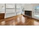Bright living room with hardwood floors, fireplace, and open access to a split level at 8536 S Upham Way, Littleton, CO 80128